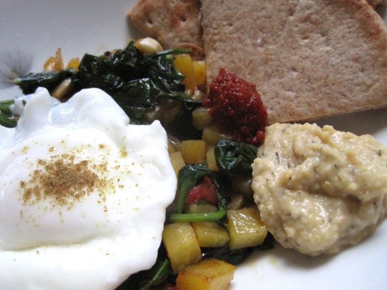 poached egg with sauteed dandelion greens golden beets hummus and pita