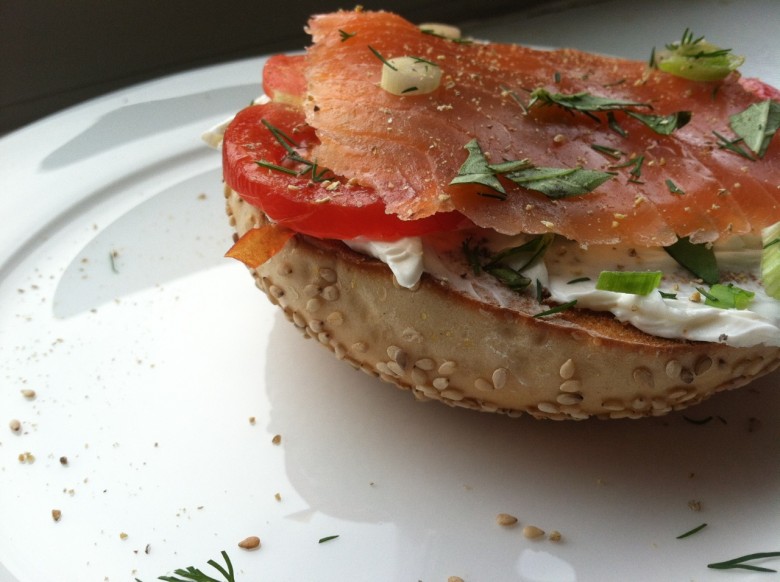 sesame bagel toasted with smoked salmon, tomato, cream cheese and fresh herbs